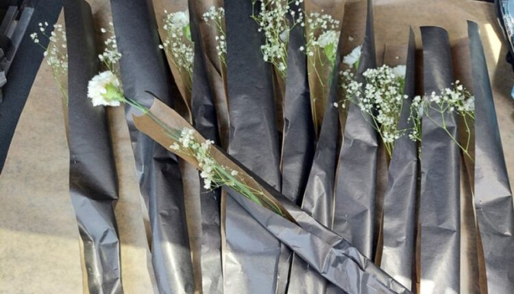 10 white carnations for the 10 lives lost in Sunday’s